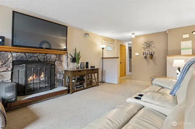 Incredibly spacious living room has a  woodburning fireplace