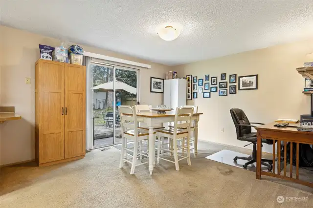 This room is currently doubling as the dining room and office area, but can also be used as a great family room
