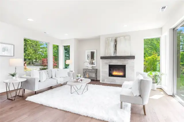 Family room with floor-to-ceiling windows and cozy gas fireplace.