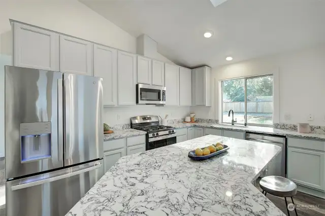 Kitchen has lots of cabinet and countertop space.