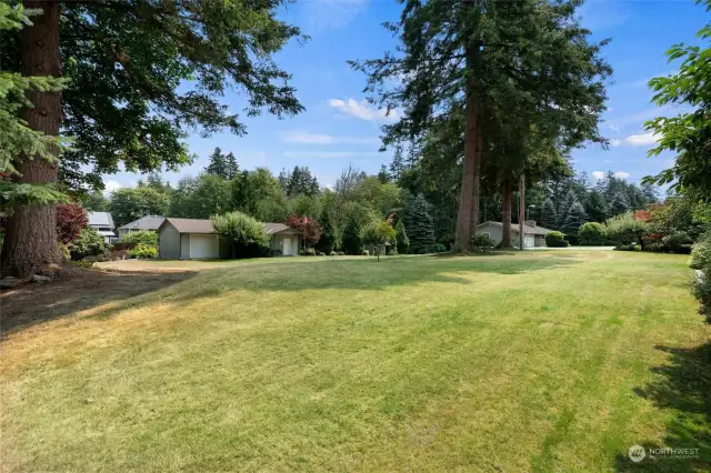 1+ acre of mature trees, and expansive lawns.