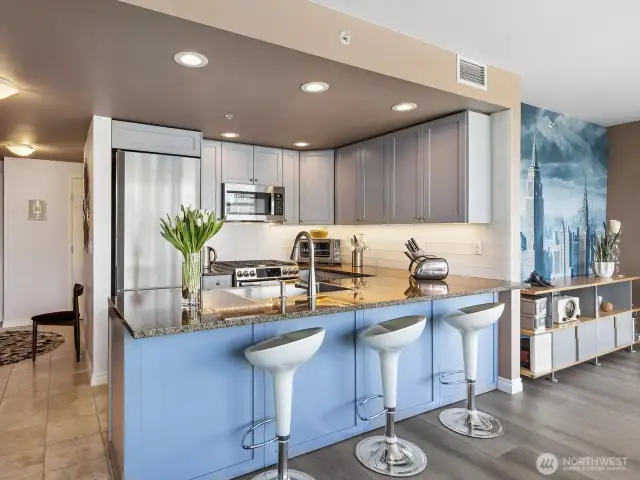 Custom painted cabinetry, frosted Italian glass for the backsplash & top of the line appliances complete this well designed kitchen.