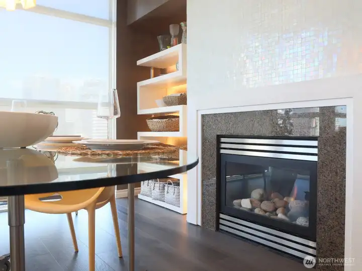 Enjoy a nice dinner right next to the beautifully refinished in Ann Sacks Opalescent Mosaic Tumbled Tile gas fireplace.
