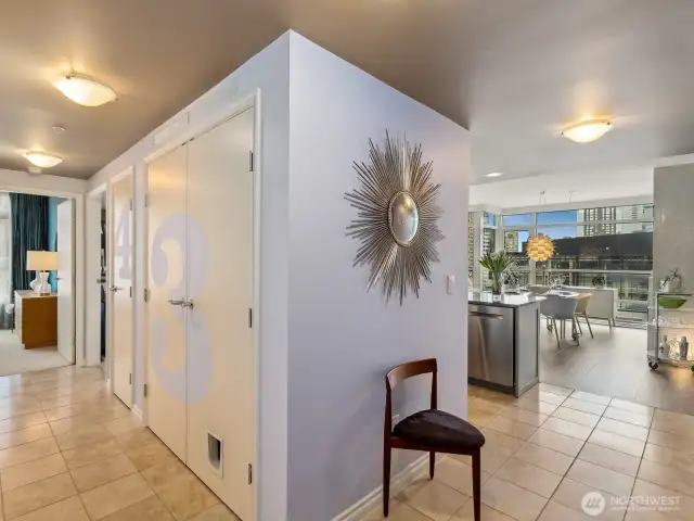 This a view from the entry of the condo. Unit 901 provides separation from the living space and bedrooms. Down the hall to the left is the bedrooms, while to the right is the open living room, kitchen and dining room.