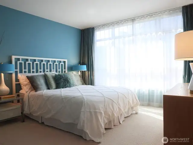 Very spacious primary bedroom with luxurious silk drapery to provide privacy.