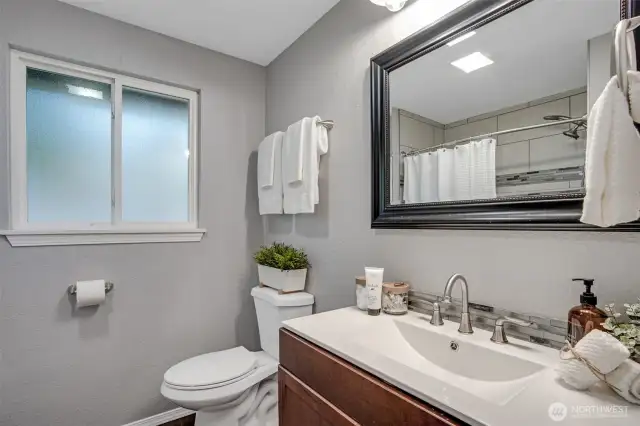 A soft gray palette gives a modern clean look to this full bath.