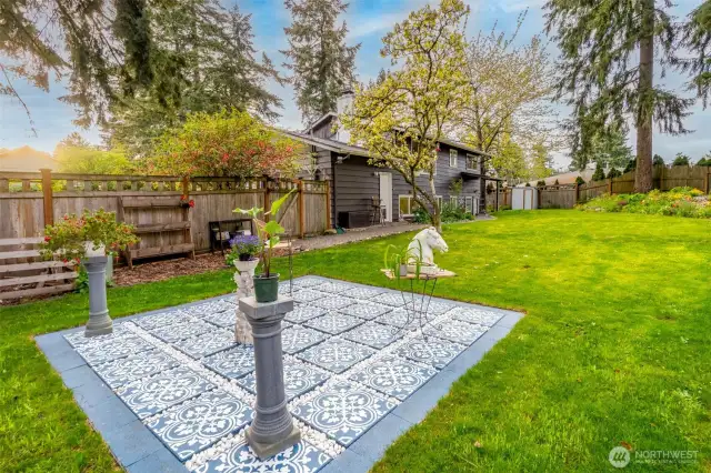 A fully fenced yard with lush green grass for pets and little ones to safely play.