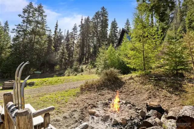 Cute fire pit area! Relax here and watch your company run snowmobiles around the meadow!