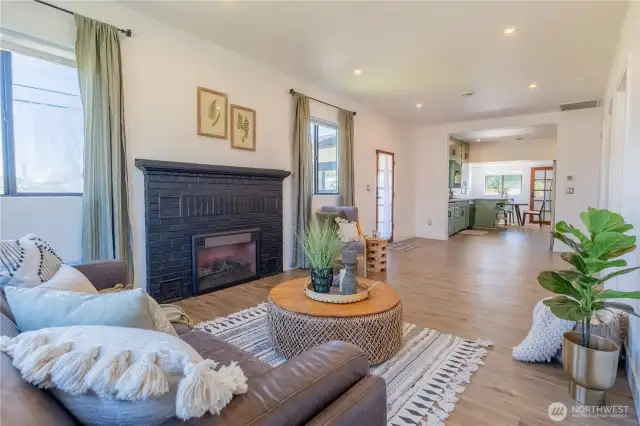 Inside be greeted by a fully updated interior including a living room with a cozy fireplace