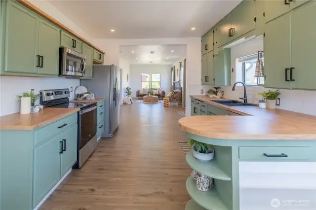 The kitchen features abundant cabinets, counter-space, and new appliances