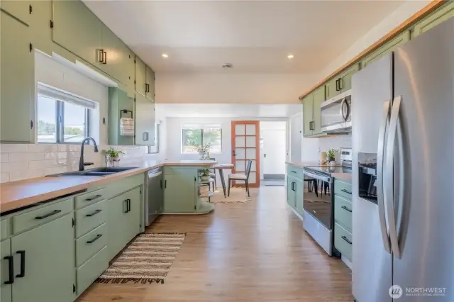 A large kitchen that opens to the side door of the home