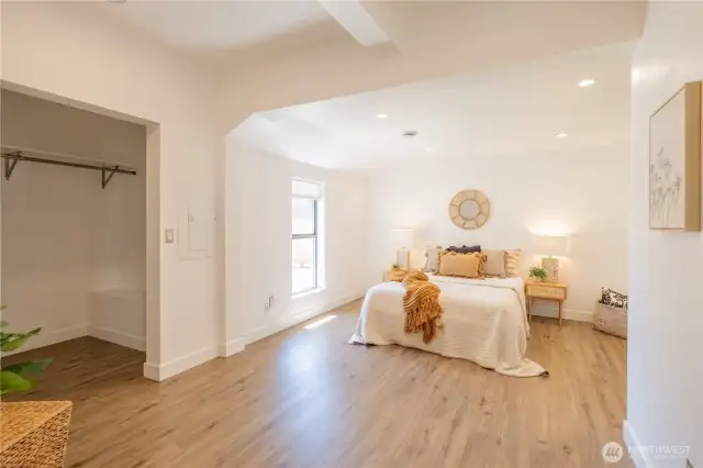 The large primary bedroom has a walk-in closet seen on the left