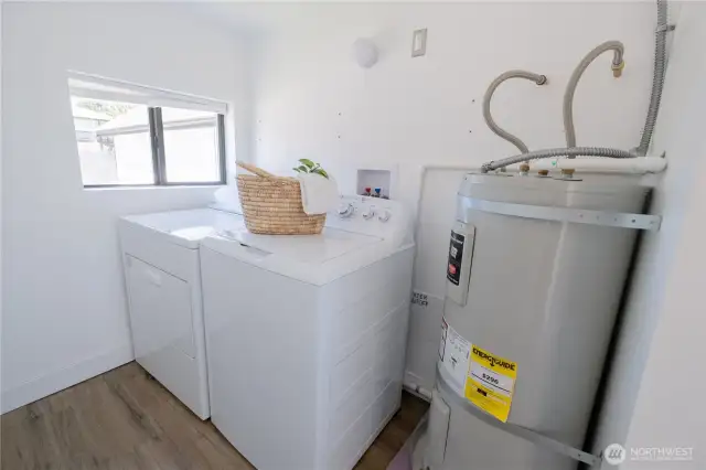 Utility room with washer and dryer and new hot water tank
