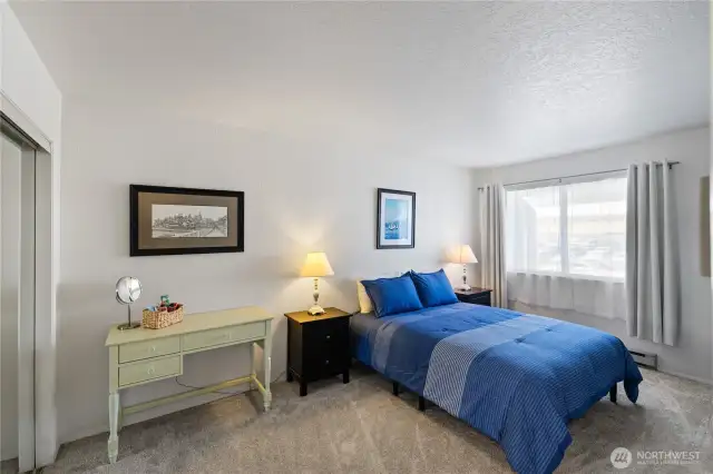 Primary Bedroom with Desk.  All Furniture is included.  The Mirrored closet is on the left.