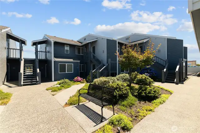 Lovely courtyard with a fountain and seating area.  The building o9n the right is the shared garage.