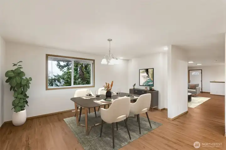 Dining has room for a large table + buffet area. New LVP flooring throughout and a view looking back at front door & living area.