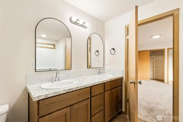Primary attached bathroom with dual vanity area & full size walk-in shower.