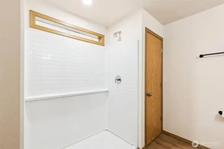 Full sized walk-in shower with linen closet & new LVP flooring.