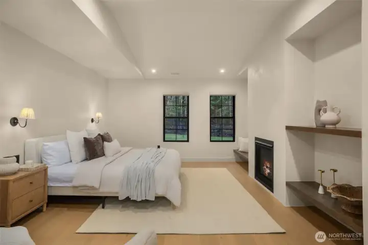 Oversized primary suite has custom built ins, and a clay gas fireplace