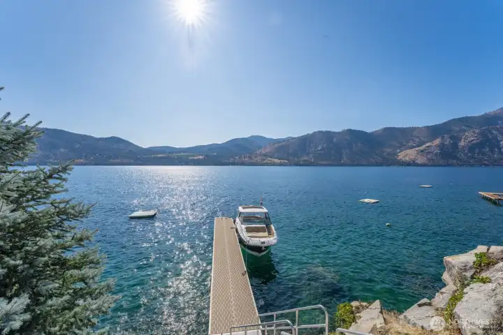 Private dock and boat lift extending into the clear waters of Lake Chelan.