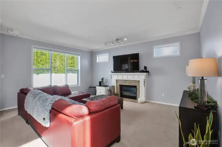 living room offers a gas fireplace and built-in speakers