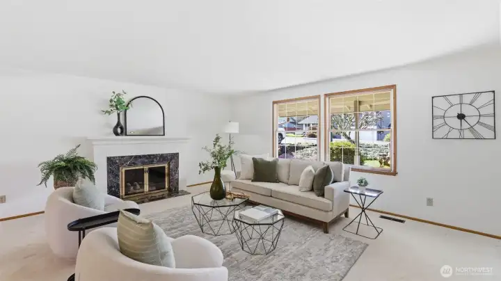 Light and bright front living room with gas fireplace.