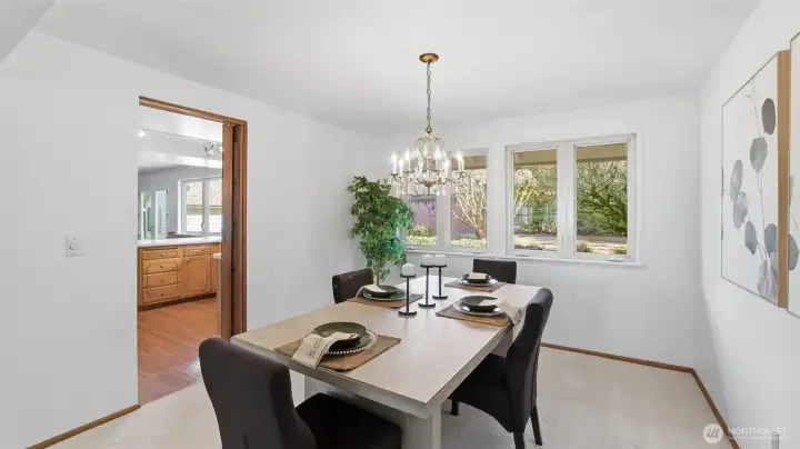 The formal dining room with chandelier flows into the kitchen.