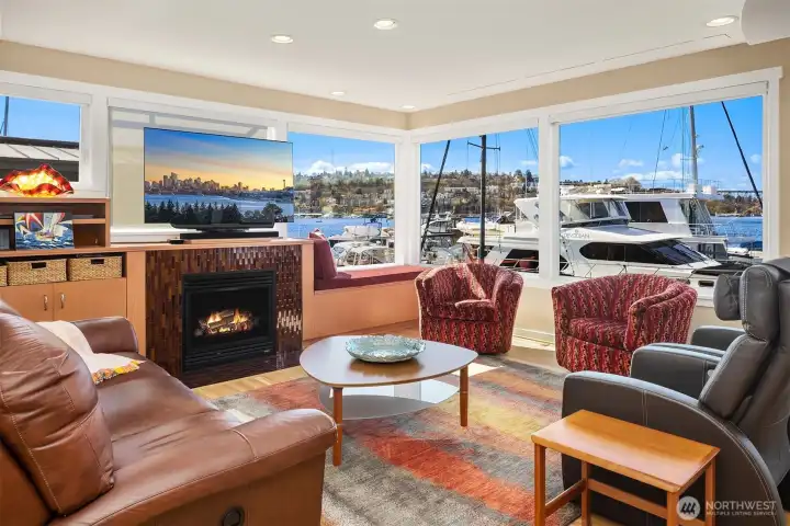 The living room's gas fireplace, built-in window seat, and drop-down movie screen make for a remarkable winter evening; the view of yachts parked just past the glass make for a remarkable summer day.