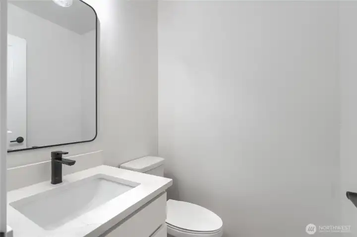 Main level Half Bath - Pics are of a different 1663 plan. Features and colors may differ.