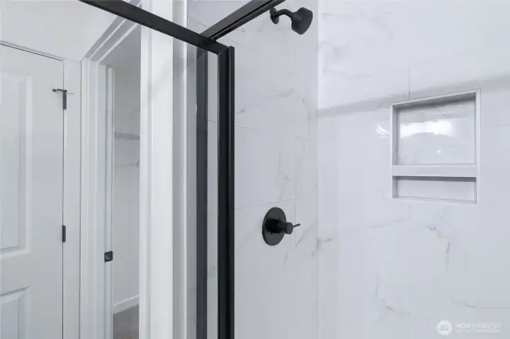 Upstairs primary bathroom with tile walled shower - Pics are of a different 1663 plan. Features and colors may differ.