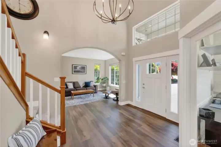 Entry opens to living room. New vinyl plank flooring throughout main level as well as fresh paint.