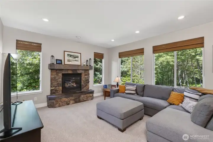 Cozy gas fireplace anchors the family room.