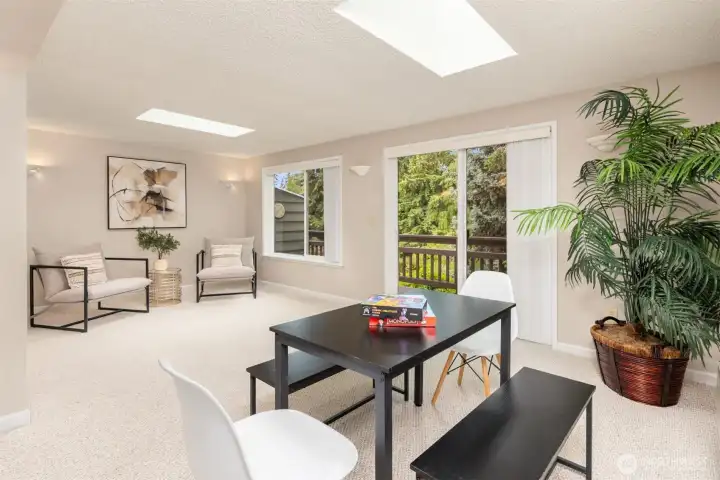 This home features a bonus room with large windows and skylights. I think of this as the sun-room area with beautiful nature views.