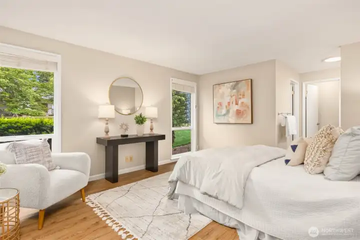 The large sized primary bedroom has large windows with attached bath.