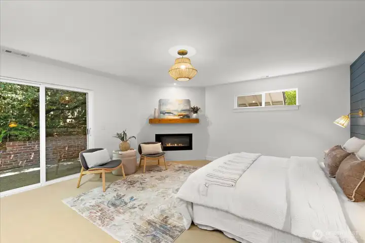 Primary bedroom with fireplace and private patio Primary bedroom with fireplace and private patio
