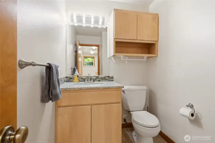 Half Bath located off utility room which is conveniently located between garage & kitchen