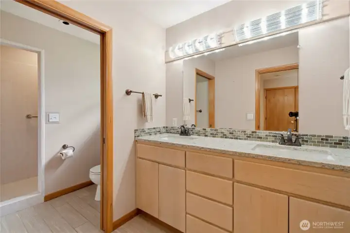 Double sinks, walk in tile shower in Primary Suite