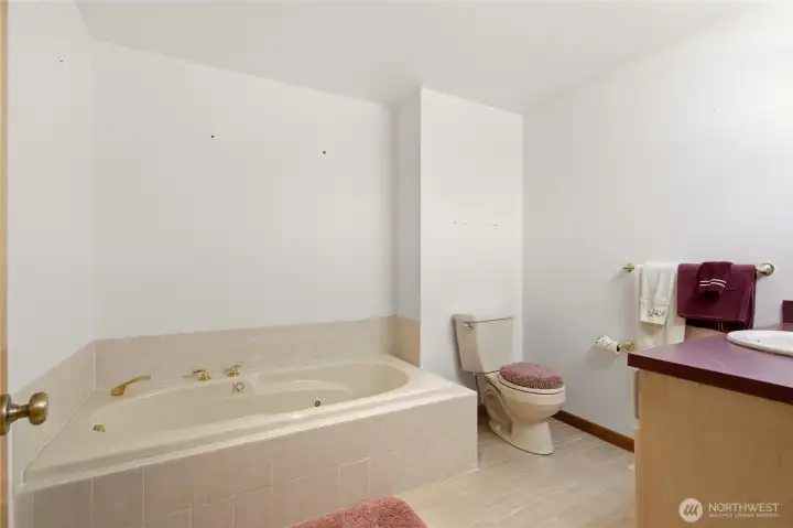 Main bath includes jetted tub & separate tile shower