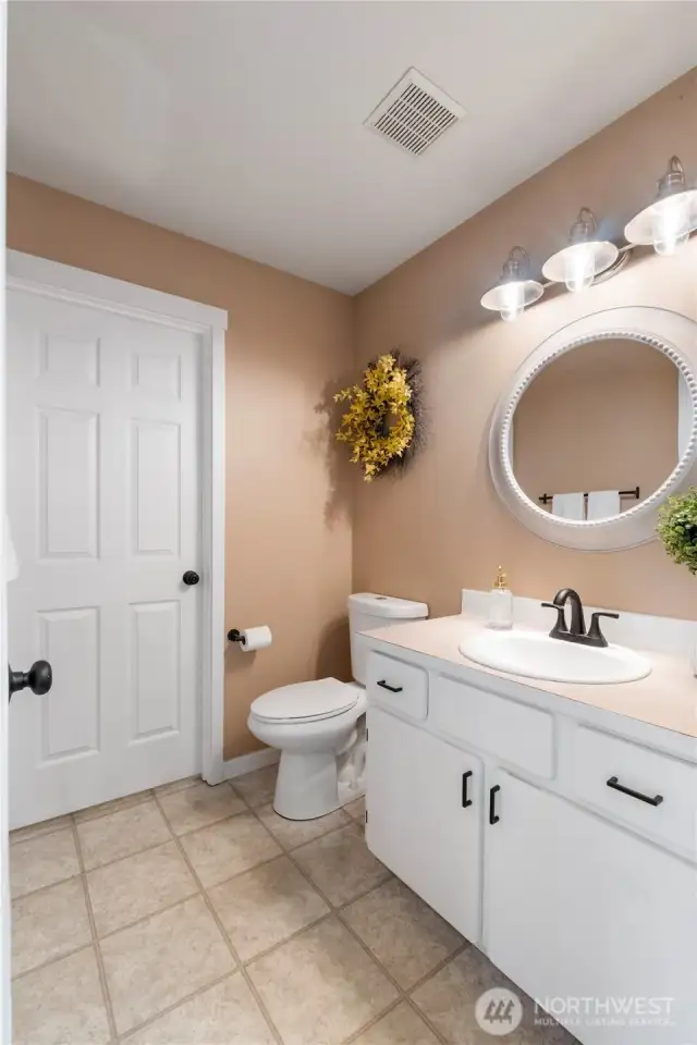Main floor half bath. Through that door is the laundry with lots of storage.