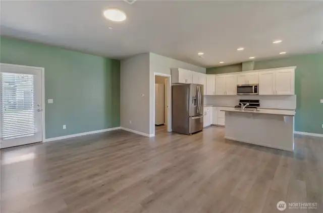 Living room, nook, kitchen, doorway to mud room/garage/1/2 bath