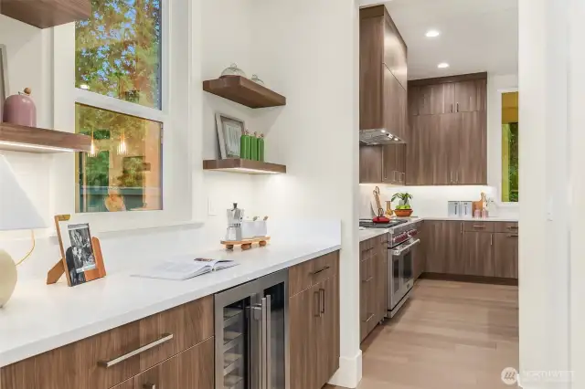 Butler’s pantry with built-in shelves, pull-out cabinets, and soft-close mechanisms. Includes an Avallon undercounter wine and beverage refrigerator for entertaining.
