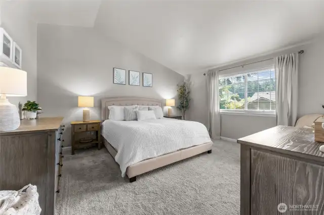 Primary bedroom with vaulted ceilings