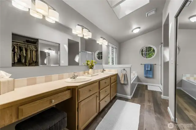 Primary bath with double sinks, soaker tub, walk-in shower and walk-in closet