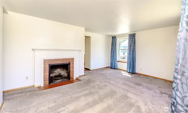Living area entrance w/wood fireplace.  HW underneath!