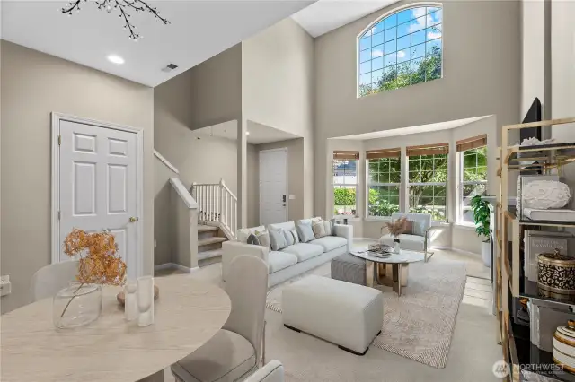 The open-concept living area is graced by soaring 20-foot ceilings that bathe the space in natural light, creating an atmosphere of airy sophistication.