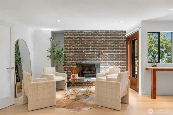Charming sitting room off the kitchen featuring one of 3 wood burning fireplaces.