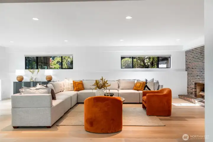 Note the scale of this rec room. It is large enough to support a generous sectional, game table, and more