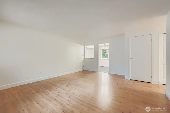 Formal living area with solid wood shutters, engineered hardwood floors and fresh paint.