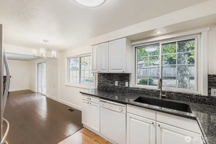 Dining area off updated kitchen features engineered hardwoods and new lighting fixture.