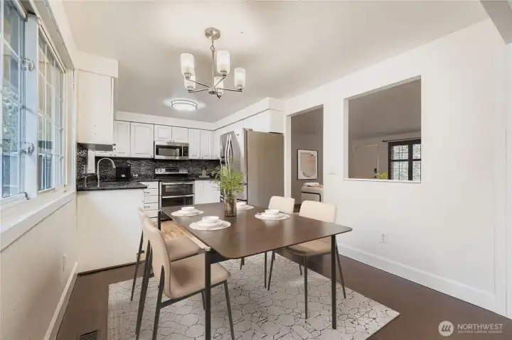 Virtually staged. Dining area off updated kitchen features engineered hardwoods and new lighting fixture. Space can accommodate up seating for up to 6.